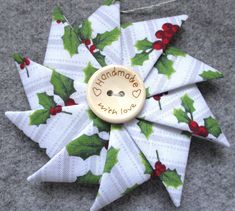 a pinwheel ornament with holly leaves on it