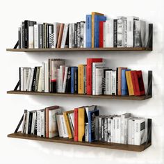 two bookshelves with many different types of books on them, one is brown and the other is white