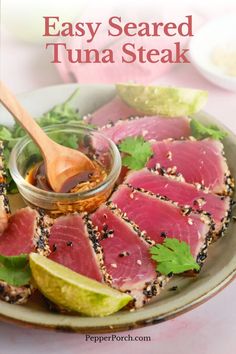 a plate filled with sliced tuna and garnished with cilantro