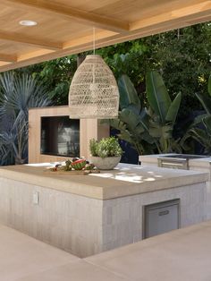 an outdoor kitchen with a grill and table