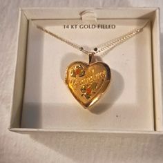 Vintage 14 Karat Gold Filled Heart Locket Engraved Grandma On The Front In Brand New Condition In Original Package Vintage Locket Aesthetic, Gold Heart Necklace Stamped 14k For Wedding, Collectible Heart Cut Gold Jewelry, Gold Heart Cut Collectible Jewelry, Gold Open Heart Jewelry For Formal Occasions, Vintage Gold Open Heart Jewelry, Double Heart Hallmark Wedding Jewelry, Gold Open Heart Vintage Jewelry, Gold Heart Necklace With Hallmark For Anniversary