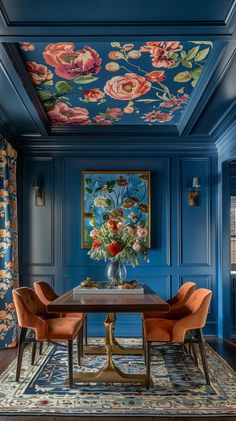 a dining room with blue walls and floral wallpaper on the ceiling, along with orange chairs