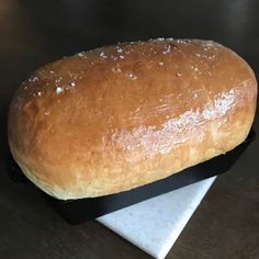 a loaf of bread sitting on top of a black and white plate next to a napkin