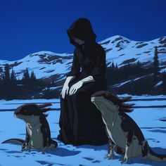 a woman sitting in the snow next to two sea lions with mountains in the background