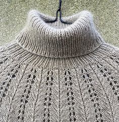 a knitted sweater hanging on a hook