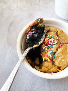 a white bowl filled with chocolate chip cookies and sprinkles