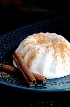 a dessert with cinnamon and whipped cream on a blue plate