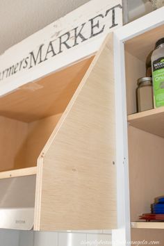 the shelves in this kitchen are made out of plywood and have labels on them