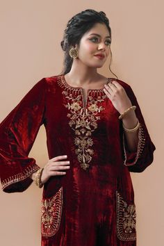 Maroon velvet kurta with bell sleeves, hand embroidery in zardozi, aari and cut dana work. Paired with pants with embroidered border and dupatta.
Component: 3
Pattern: Embroidered
Type Of Work: Zardozi, Aari and Cut Dana Work
Neckline: Notched Round
Sleeve Type: Bell Sleeves
Fabric: Velvet
Color: Maroon
Other Details: 
Side slits on kurta
Embroidered patch pockets on kurta
Embroidered bordered dupatta
Closure:
Pants: Side zip
Occasion: Sangeet,Haldi and Mehendi - Aza Fashions Velvet Dresses Outfit, Velvet Outfit, Velvet Suit Design, Velvet Kurta, Pakistani Women Dresses, Embroidery Fashion Detail, Velvet Dress Designs, Kurta Set For Women, Aesthetic Dress