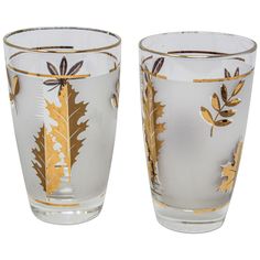 two clear glass vases with gold leaf designs