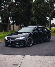 a black car is parked on the street