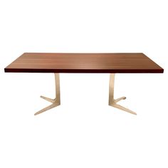 a wooden table with two metal legs and a white base on an isolated white background