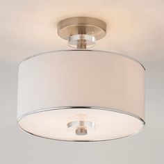 a ceiling light with a white shade on it