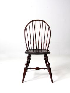 a wooden chair sitting on top of a white floor