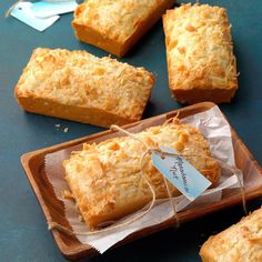 several pieces of bread tied with twine on top of a wooden tray