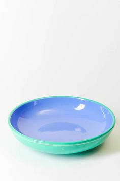 a blue bowl sitting on top of a white table