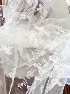 the veils and shoes are all covered in white lace, which has been placed on top of each other