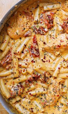 a pan filled with pasta and sauce on top of a table