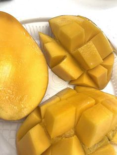 two pieces of mango sitting on top of a plastic plate