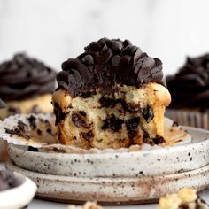 cupcakes with chocolate frosting and oreo cookies