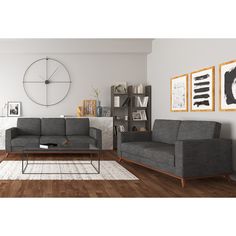 a living room with two couches and a coffee table in front of the wall