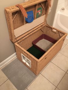 an open suitcase sitting on top of a bathroom floor