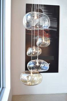 a glass chandelier hanging from the ceiling next to a window