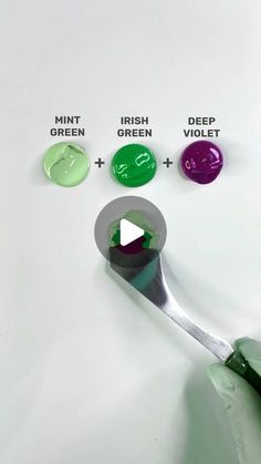 three different colors of paint being used on a spoon