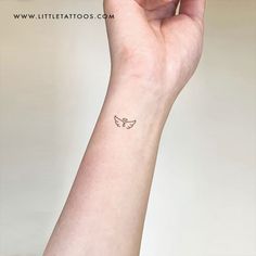 a woman's arm with a small tattoo on the left side of her wrist