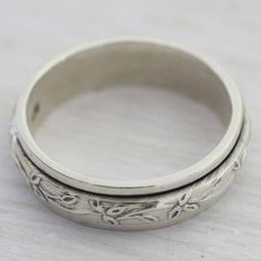 Petite leaves that capture the spirit of the forest spin around a simple band in this meditation ring from India. Following in the footsteps of his father Bhavesh designs this spinner ring working with local artisans to craft it from sterling silver with a shining appearance.