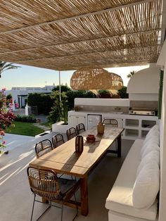 an outdoor kitchen and dining area is shown