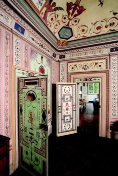 an ornately decorated room with painted walls and doors