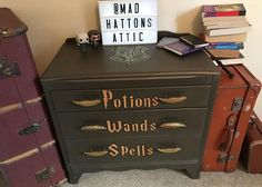 a harry potter dresser with lots of books on it and a sign that says pottons wands spells