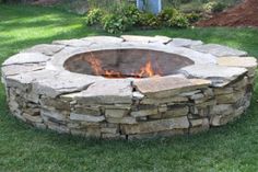 an outdoor fire pit in the grass