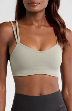 Signature Dri-FIT tech keeps you dry and comfortable in this strappy sports bra with a foam pad insert for extra coverage. Elasticized straps Dri-FIT moisture-wicking technology Lined 63% nylon, 37% spandex Machine wash, line dry Imported Solid Compressive Activewear With Straps, Compressive Strappy Activewear With Straps, Compressive Strappy Activewear, Moisture-wicking Strappy Sports Bra, Breathable Strappy Sports Bra For Light Exercise, Adjustable 4-way Stretch Sports Bra For Light Exercise, Adjustable Straps Sports Bra For Light Exercise, Strappy Moisture-wicking Sports Bra For Pilates, Functional Strappy Activewear With Light Support