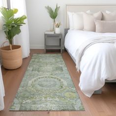 a bed with white sheets and pillows in a bedroom next to a green rug on the floor