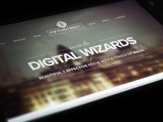 the website for digital wizards is displayed on a tablet screen in this photo, it appears to be dark and blurry