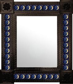 an ornate mirror with blue and gold designs on the edges, against a white background