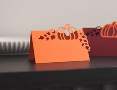 three paper pumpkins are sitting on a table