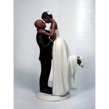 a bride and groom figurine kissing each other