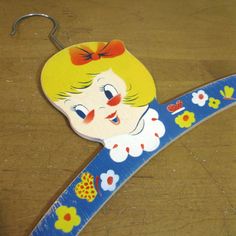 a blue and yellow ribbon with a cartoon girl on it