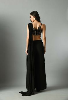 Moonshine, our pre-draped saree in black and it is elegant and fuss-free and A stunning Nylah bustier to make your outfit look unique. Add a touch of style to your wardrobe with the Moonshine pre-draped saree with nylah bustier set. Crafted in crepe silk, it is adorned with zari Embroidery. The black color will add a subtle and elegant touch to your look.Composition and care Crepe silk Hand wash or dry clean only GARMENT MEASUREMENTS Size Bust Waist Hip Neck Shoulder Arm Hole XS 32” 26” 35” 13” 14” 13” S 34” 28” 37” 13.5” 14.5” 14” M 36” 30” 39” 14.5” 15” 15” L 38” 32” 41” 15.5” 15.5” 16” XL 40” 34” 43” 16.5” 16 17” Ships Worldwide from India.MADE IN INDIA Saree In Black, Draped Saree, Zari Embroidery, Drape Saree, Black Color, Custom Made, Dry Clean, Hand Wash, Saree