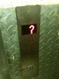 an elevator with a red question mark on the front and bottom panel that says, you are not entering the elevator level