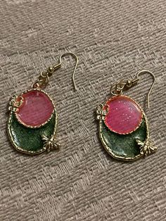 Pink and green in an oval bezel earrings with butterflies on them Green Oval Earrings As Gift, Green Oval Earrings For Gift, Green Oval Nickel-free Earrings, Bezel Earrings, Pink And Green, Jewelry Earrings Dangle, Butterflies, Dangle Drop Earrings, Dangle Earrings