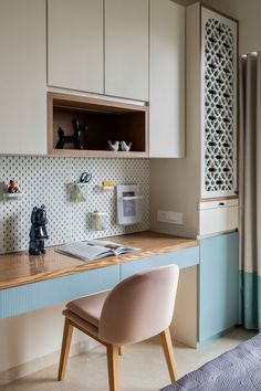 a chair sitting on top of a wooden desk next to a cabinet filled with items