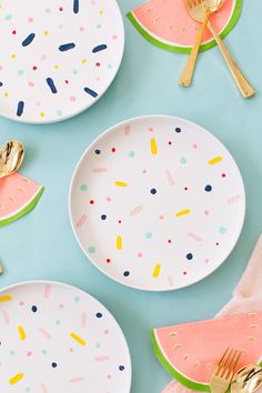 watermelon slices and sprinkles on plates with gold forks