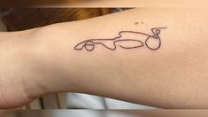 a person with a small tattoo on their arm that has a car drawn on it