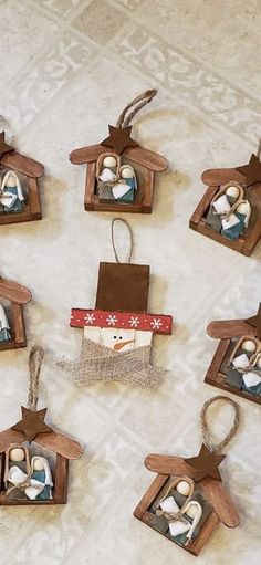 six wooden nativity ornaments hanging on a wall