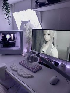 a desk with a computer, keyboard and headphones on it