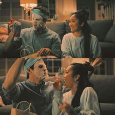 two people sitting on a couch and one is wearing a face mask while the other looks at